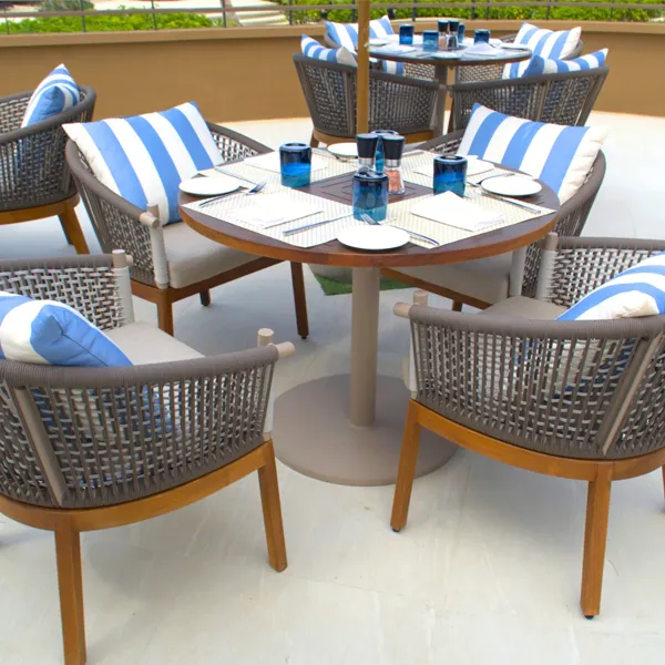 Beachfront restaurant seating with blue umbrellas at Angsana Laguna